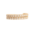 A gold flexi wrap around ring with diamond stones against a white background.
