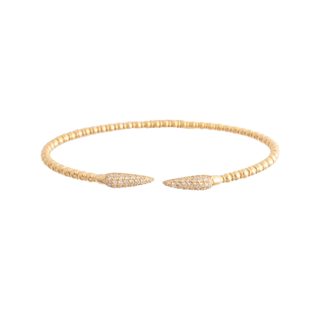 Gold bracelet with leaf-like ends on a white background