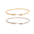 Two flexi bracelets, one yellow gold and one white gold on a white background