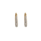 A pair of 14k gold Claw Diamond Huggie Earrings with a V-shaped design and diamond embellishments.