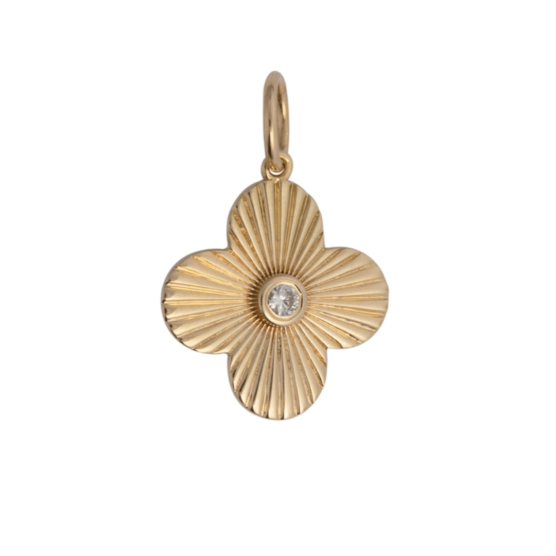 A gold-colored pendant featuring a clover-shaped design with a blue sapphire center stone.