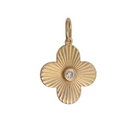 A gold-colored pendant featuring a clover-shaped design with a blue sapphire center stone.