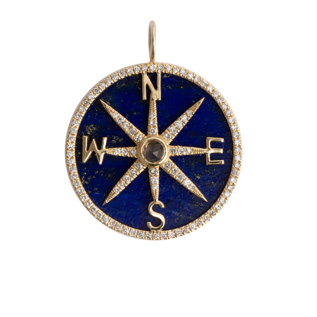 A blue lapis and diamond pendant set in 14k gold.