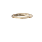 A gold band ring with diamonds set around the top edge.