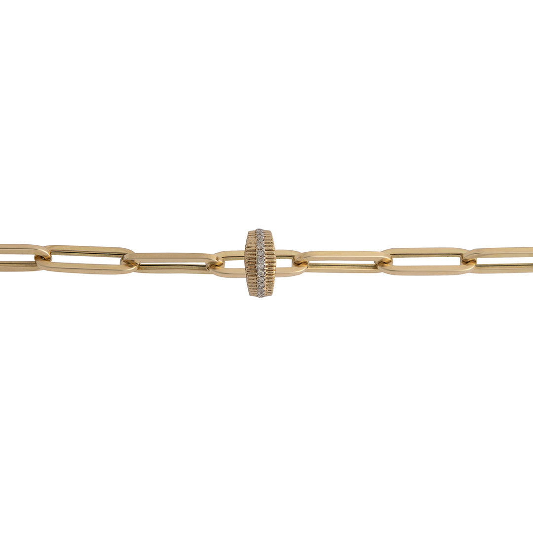 A 14k gold paperclip chain with a curved edge diamond roundel bead made of 14k gold with a pattern of inset and prominent diamonds creating a roundel design.