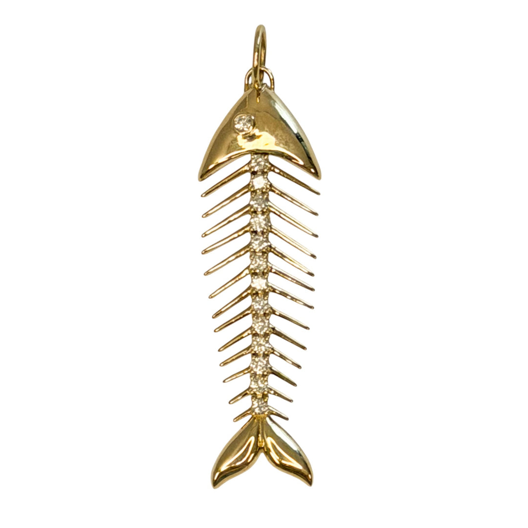 A 14k gold fish skeleton pendant accented with diamonds on a white background. 