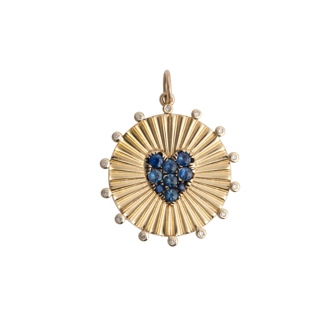 Gold pendant with a heart-shaped blue sapphires  on a white background