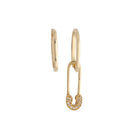 A pair of gold earrings, one shaped as an elongated oval hoop and the other as an edgy safety pin with diamond accents.
