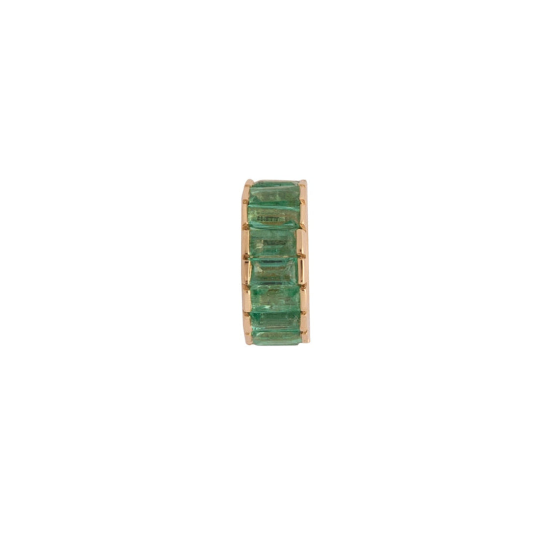 Green roundel bead with embedded emerald stones on a white background