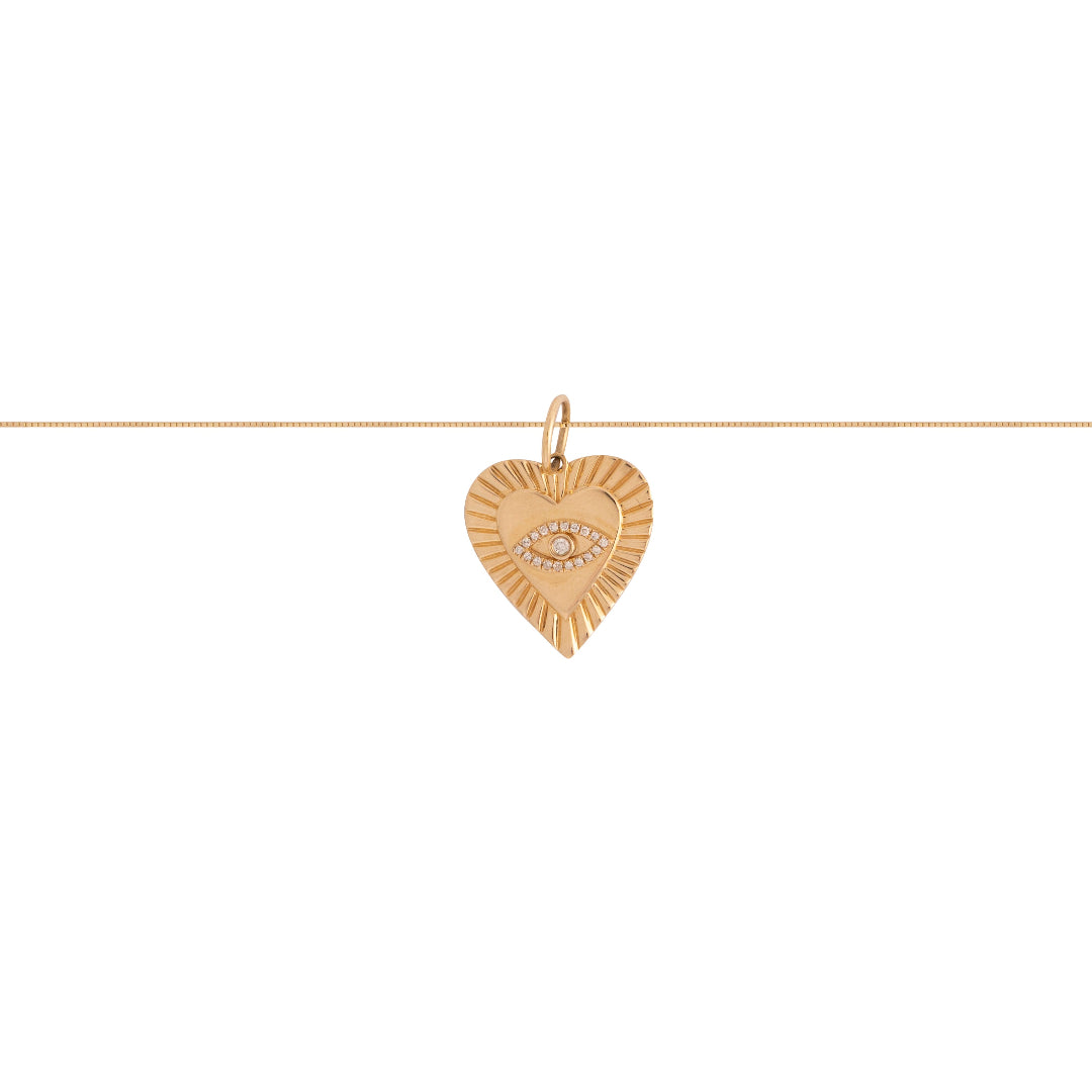 An gold heart pendant with an evil eye pendant on a gold chain. 