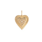 A gold heart pendant with an evil eye set on a 