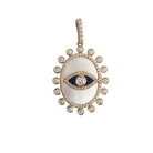 A 14k gold pendant featuring a mother of pearl and lapis center with a surrounded by a row of sparkling diamonds, with a built-in clip for attaching to a chain.