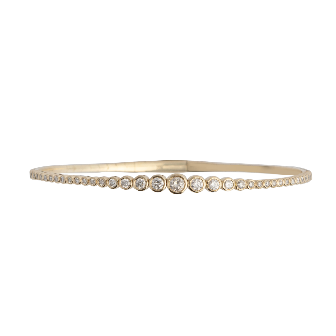 A diamond bracelet with graduated bezel set diamonds. 