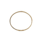 Sideways view of a gold bracelet on a white background