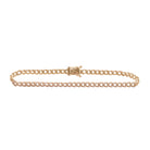 A gold Cuban link chain bracelet with diamond accents, displayed against a white background.