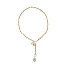 A 14k gold rolo lariat necklace with a 14k gold Hamsa diamond mini pendant and a larger mother of pearl and diamond evil-eye pendant on a white backgroud. 