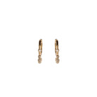 A pair of gold hoops with dangling bezel set diamonds on a white background.