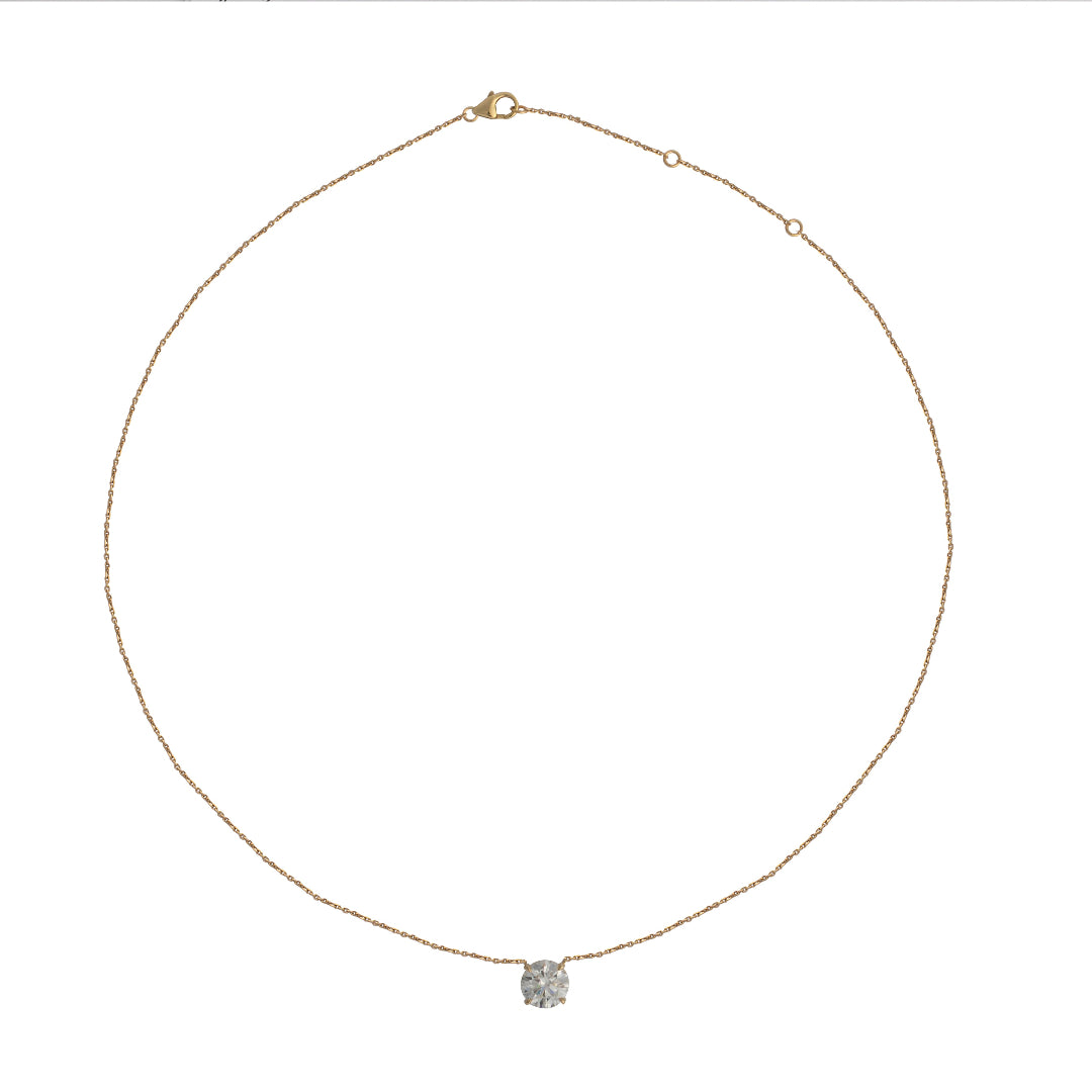 Delicate gold necklace with a solitare lab grown diamond pendant on a white background