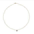 Delicate gold necklace with a solitare lab grown diamond pendant on a white background
