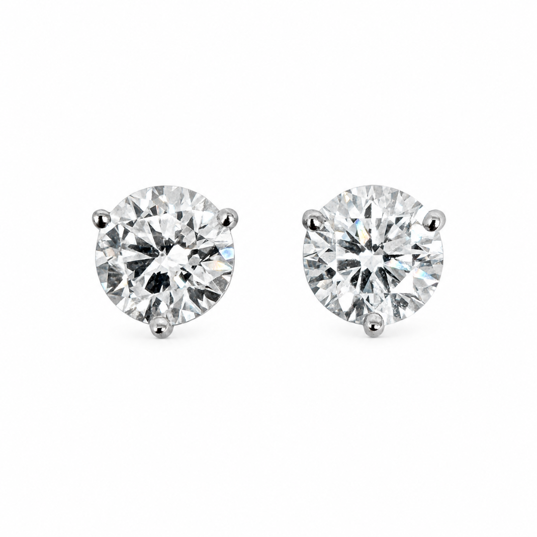 Lab-grown diamond studs set in white gold on a white background. 
