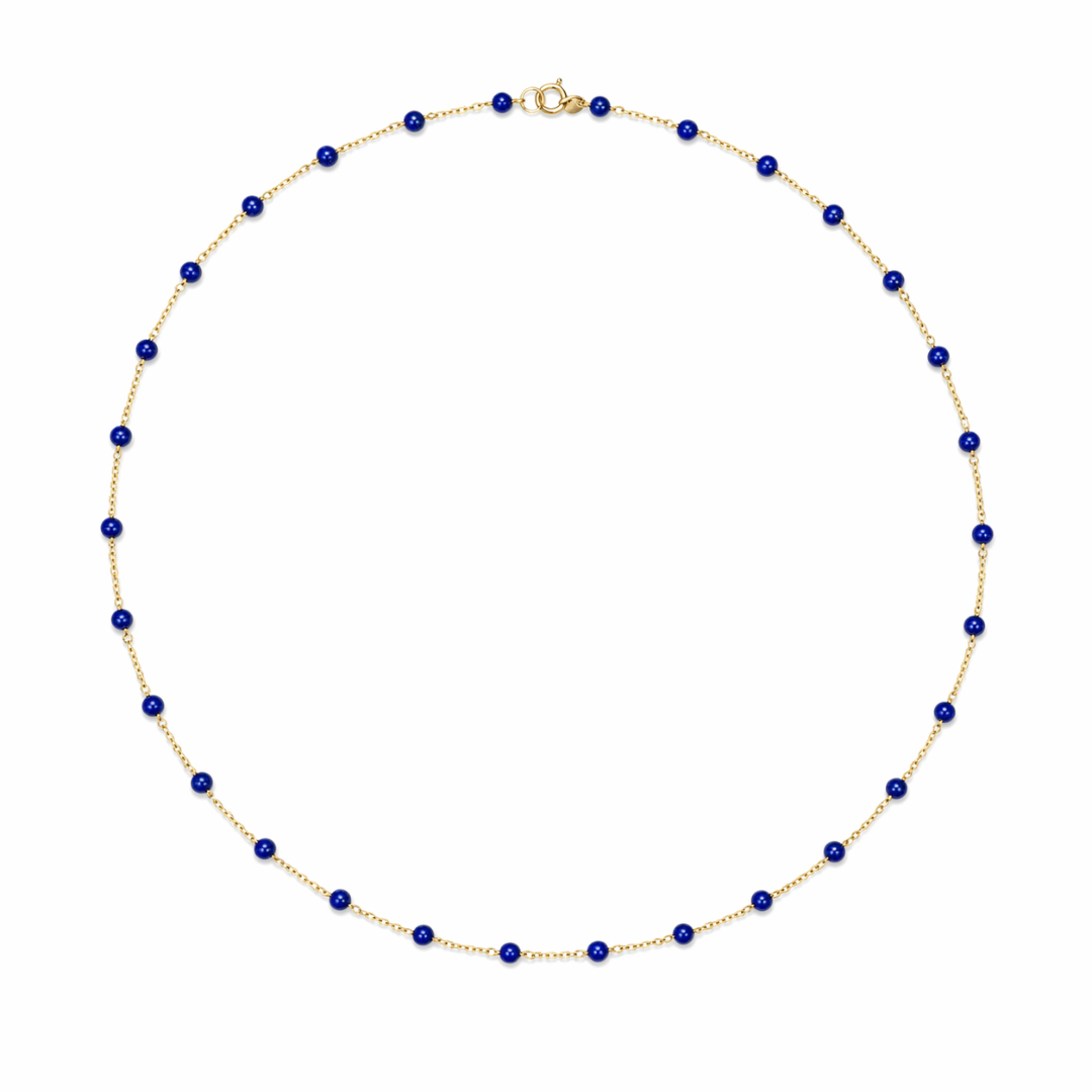 14k gold chain with lapis beads on a white background. 