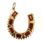 14k gold pendant with garnets on a white background.