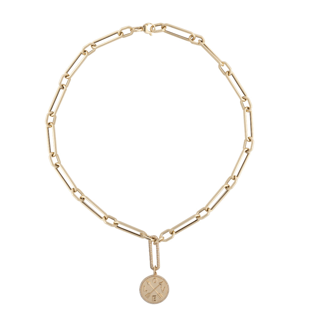 A white background showcasing a chunky gold necklace with a gold pendant attached via a diamond link. 