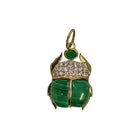A scarab pendant set in 14k gold featuring malachite, diamond pavé and green onyx on a white background. 