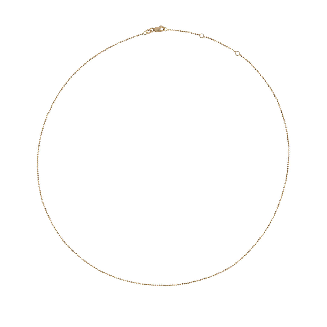 Gold ball chain necklace on a white background