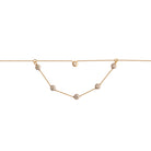 Gold necklace with white and yellow gold bezel set diamonds on a white background