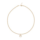 Gold necklace with a small pendant on a white background