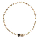 A 14k gold paperclip chain necklace with diamond and emerald roundel beads on a white background.