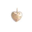 Gold heart-shaped pendant with embedded gemstones on a white background