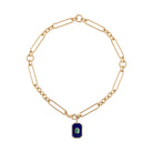 A 14k chunky link chain with a laps, emerald and diamond pendant attached at the clasp. 