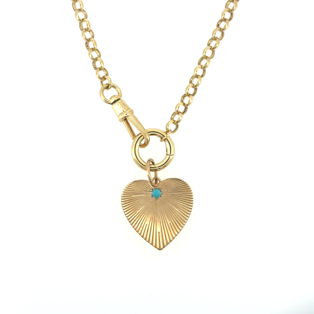 A 14k gold rolo chain styled as a traditional necklace, with a gold and turquoise attached; on a white background. 