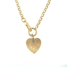 A 14k gold rolo chain styled as a traditional necklace, with a gold and turquoise attached; on a white background. 