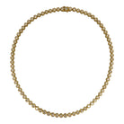 A 14k gold round bezel set tennis necklace on a white background.