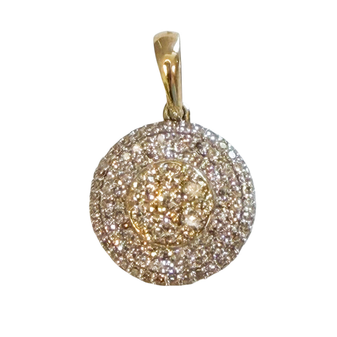 A 10k yellow and white gold round shaped pendant with pavé diamond on a white background.