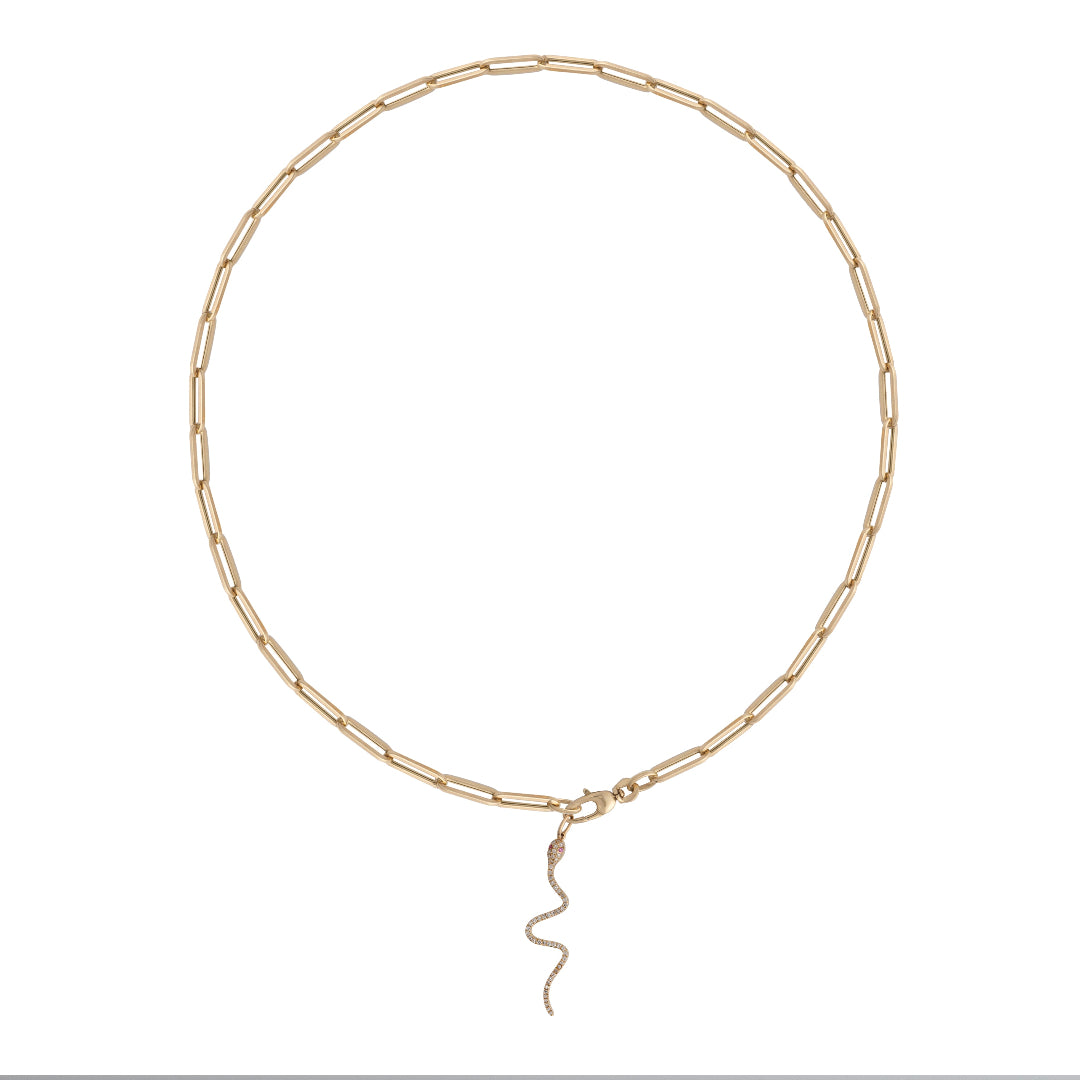 A gold paperclip chain with a serpent diamond pendant attached. 