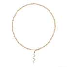 A gold paperclip chain with a serpent diamond pendant attached. 