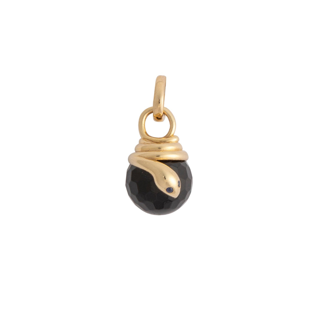 Gold and black onyn pendant on a white background