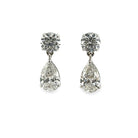 A pear of Solitare Studs with Pear Lab-Grown Diamond Drop Earrings on a white background. 