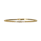 14k gold flexible bracelet with diamonds in the center on a white background.