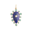 Gold pendant with a blue stone and turquoise accents on a white background