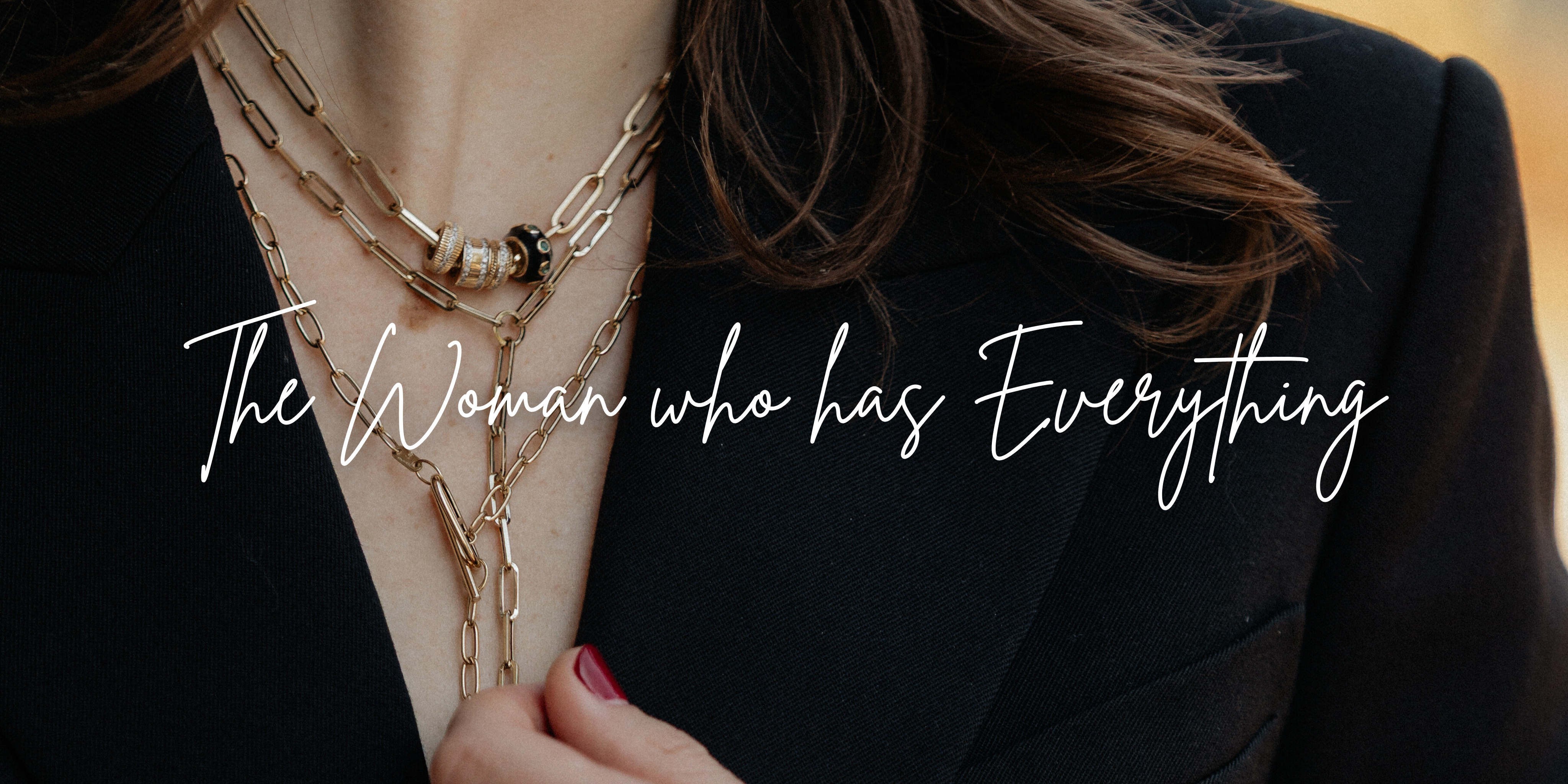 Close-up of a woman wearing multiple necklaces with a blurred background and text overlay.