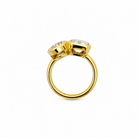 A close-up of a person's hand wearing a 14k yellow gold  bezel set moi et toi ring, resting on a cream and rust-khaki knit sweater.