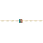Gold necklace with gemstone beads on a white background.
