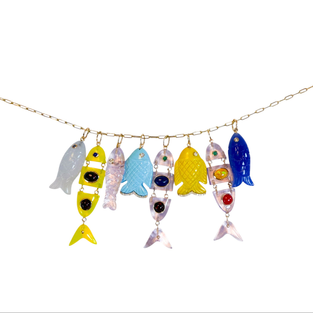 Numerous colorful fish-shaped pendants on a 14k gold chain set on a white background. 