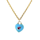 A 14k gold chain necklace featuring a turquoise heart-shaped pendant with a small teardrop-shaped pink topaz in the center, set against a plain white background.
