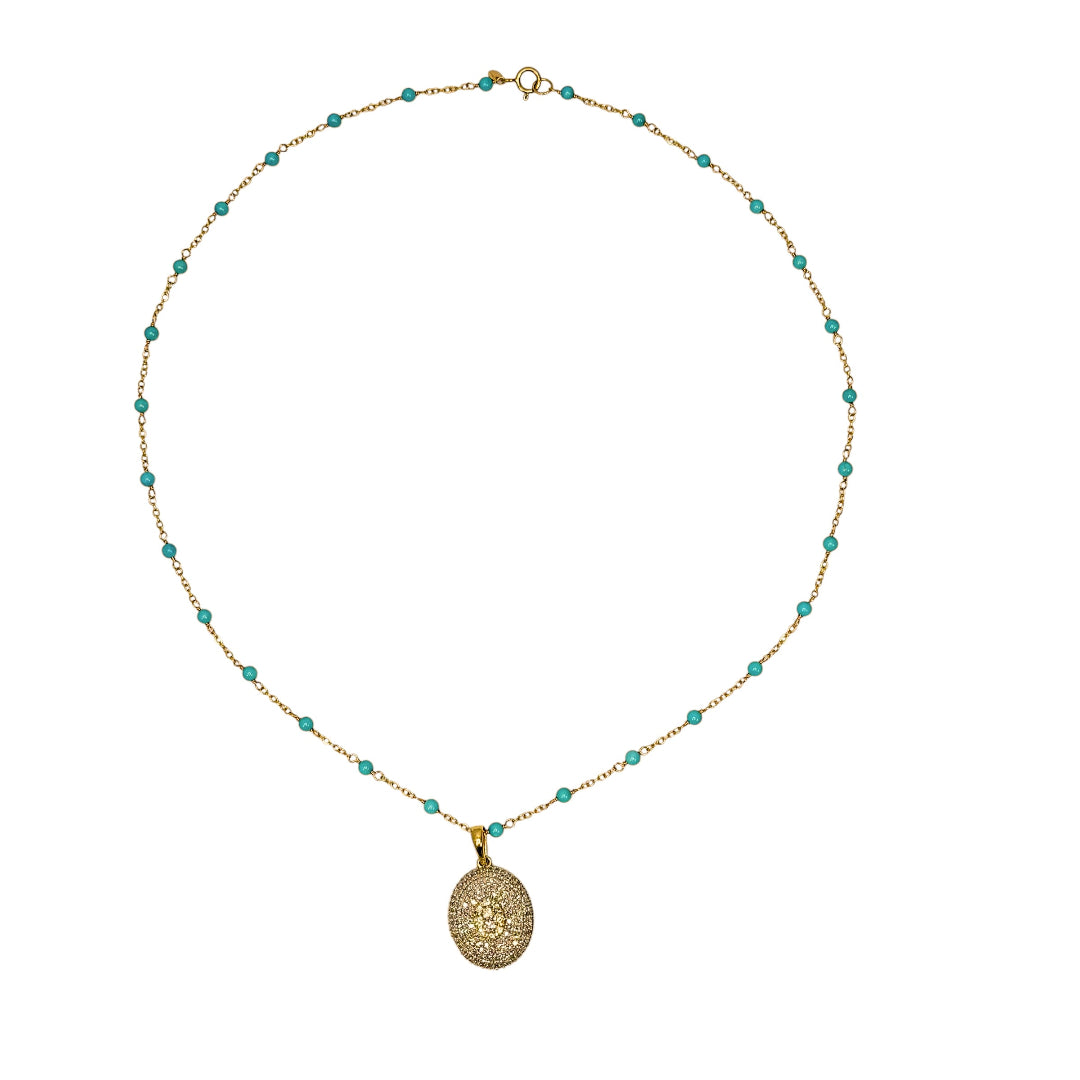 14k gold necklace with turquoise beads and a pavé diamond gold pendant on a white background. 